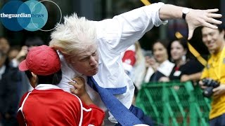 Boris Johnson knocks over boy in rugby match in Japan [upl. by Honebein]