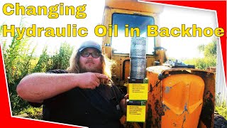 Changing Hydraulic amp Transmission Oil In John Deere 410 Loader Backhoe [upl. by Ateiluj]